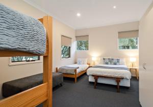 two beds in a room with two beds sidx sidx sidx sidx sidx at Crystal Brook Lodge in Dinner Plain