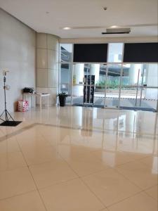 a large room with a large white tiled floor at Cubao ManhattanHeights Unit 7EF Tower B, 1BR in Manila