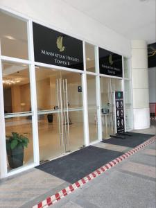 an entrance to a building with revolving doors at Cubao ManhattanHeights Unit 7EF Tower B, 1BR in Manila +51 photos
