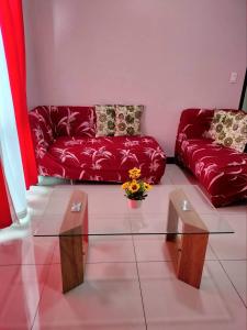 a living room with a red couch and a glass table at Cubao ManhattanHeights Unit 7EF Tower B, 1BR in Manila
