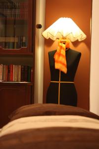 eine Schaufensterpuppe mit einer orangefarbenen Fliege und einer Lampe in der Unterkunft B&B Principe all'Arena in Verona