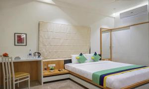 Letto o letti in una camera di Treebo The Utsav, Nashik