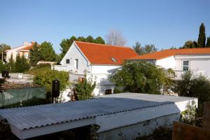 a view of a house with a roof at Apartments with a parking space Sabunike, Zadar - 5822 in Privlaka