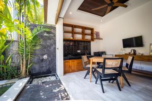 a dining room with a table and chairs at Tamantara in Ubud