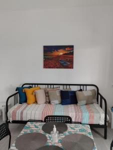 a bed with colorful pillows on it in a room at Nikolas' house in Nea Iraklia