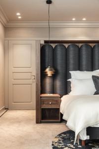 a bedroom with a large bed with a black headboard at Hotel 717 in Amsterdam