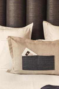 a bed with a black and white pillows and a box on it at Hotel 717 in Amsterdam