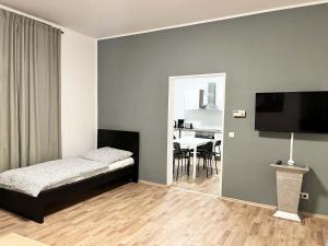 a bedroom with a bed and a television on a wall at cosy three room apartment with flatscreen TV in Recklinghausen