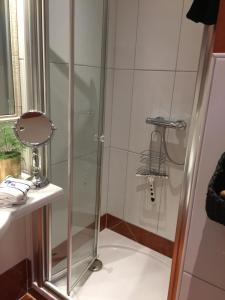 a shower with a glass door in a bathroom at Appartement Lotte in Kiel
