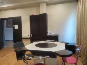 a room with a table and some chairs at Hotel Rudraksh- Near VIP Airport Guwahati in Guwahati