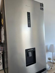 un frigorifero in acciaio inossidabile con un distributore d'acqua di Karakonero view apartment a Città di Rodi