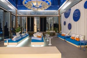 a lobby with blue furniture and blue ceilings at The Yama Hotel Phuket - SHA Extra Plus in Kata Beach