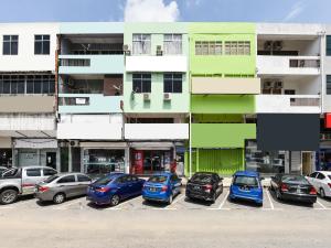 a group of cars parked in a parking lot at SPOT ON 89872 Kuantan Backpackers in Kuantan