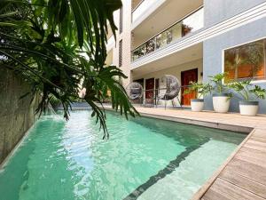 a swimming pool in front of a house at Bill Tourist Inn in El Nido