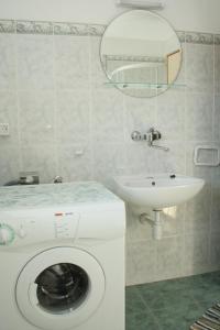 a bathroom with a washing machine and a sink at Apartments by the sea Lumbarda, Korcula - 4445 in Lumbarda