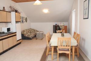 a kitchen and a dining room with a table and chairs at Apartments by the sea Lumbarda, Korcula - 4445 in Lumbarda