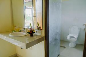 a bathroom with a sink and a toilet at Desak Putu Putra Home Stay in Ubud