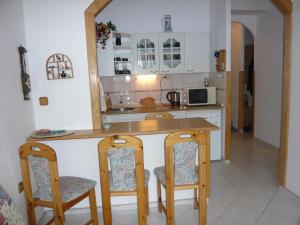 a kitchen with a table and chairs and a counter at Apartmá Ježková in Vrchlabí