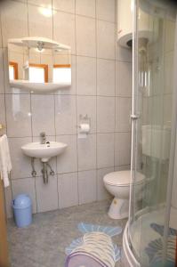 a bathroom with a toilet and a sink at Apartments by the sea Brna, Korcula - 4333 in Brna