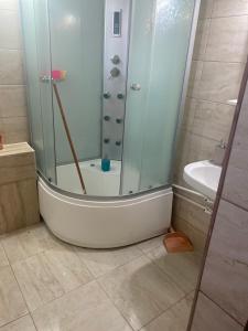 a bath tub in a bathroom with a shower at La Mare Darius Mihai in Mamaia Nord