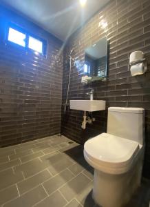 a bathroom with a white toilet and a sink at Yuh-Tarng Hotel in Magong