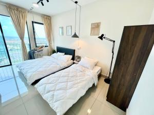 a bedroom with two beds and a large window at A 1-4 pax Cozy Studio TV Box Pool 100mps Wifi 3 bed Trefoil Setia Alam in Setia Alam