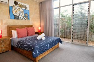 a bedroom with a bed and a large window at Arthouse, beach 200m, kids TV area, air-con in Dunsborough