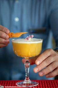 a person is holding a cocktail in a glass at Holiday Inn Express Amsterdam - North Riverside by IHG in Amsterdam