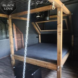 a wooden bunk bed with a blue mattress at Love Apartmanok Eger in Eger