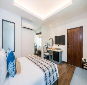 a hotel room with a bed and a desk at NH Collection Samui Peace Resort in Bophut