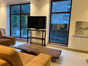 a living room with a flat screen tv and a couch at Dilijan Mountain View, 3 bedroom house in Dilijan