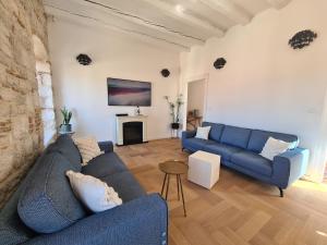 a living room with two blue couches and a fireplace at Apartment Tomazina (seaview,central, heritage) in Vis