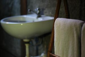 a bathroom with a sink and a towel at Rumah Tembi in Yogyakarta