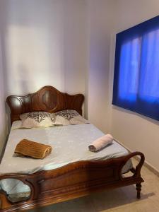 a bed with two towels on it in a bedroom at Beach house Cala Morlanda in S'Illot