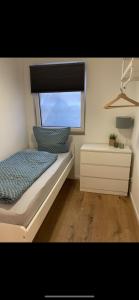 a small bedroom with a bed and a window at ZEITraum1 Gummersbach in Gummersbach