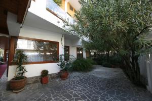 a courtyard with trees and potted plants in a building at Villa Alba Boutique Hotel in Pescara
