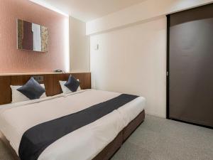 Letto o letti in una camera di Seiei Hotel Kyoto Kawaramachi