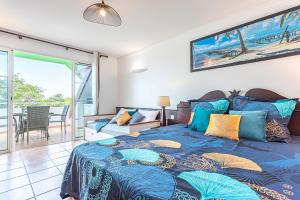 a bedroom with a bed with a view of the ocean at Studio Karuker'As - Aouara 1326 in Sainte-Anne