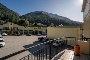 a balcony with a view of a parking lot at Snowy Peaks - Queenstown Holiday Apartment in Queenstown
