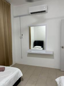 Cette chambre blanche dispose d'un miroir et d'un lit. dans l'établissement OrchidVilla Homestay at Southville Apartment, à Kampong Parit