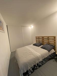 a bedroom with a bed in a white room at perle rare à la ciotat in La Ciotat