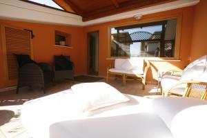 a patio with chairs and a table and a window at Villa Alba Boutique Hotel in Pescara
