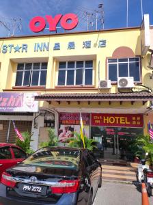 a car parked in front of a hotel at Hotel Star Inn in Teluk Intan