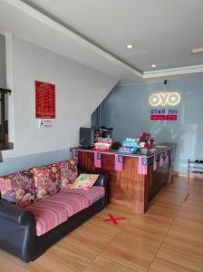 a living room with a couch and a counter at Hotel Star Inn in Teluk Intan