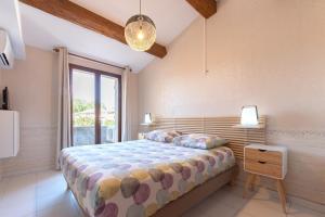 a bedroom with a bed and a large window at MAISON COSY avec petite piscine in Six-Fours-les-Plages +19 photos