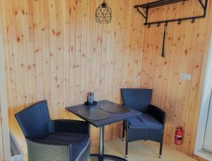 a small table and two chairs in a room at Tiny and cosy house in the countryside in Hella