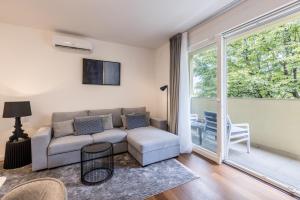 a living room with a couch and a large window at Apartment FORTUNA in Split