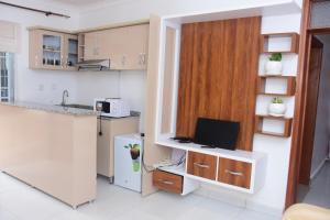 a kitchen with a desk with a computer on it at Silent Hill Hotel Kayonza in Kayonza