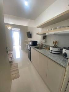a kitchen with a sink and a counter top at 1BR unit in South Residence Las Pinas with Wifi & Netflix in Manila