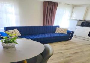a living room with a blue couch and a table at 2 bedroom serviced apartment # in London